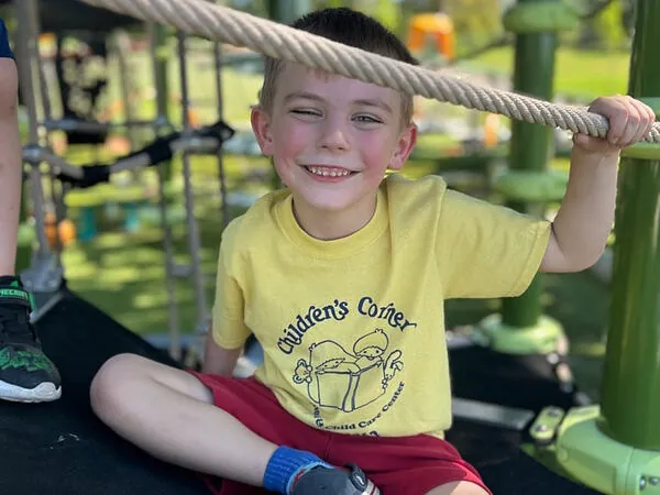 A Children's Corner kindergartner on the playground climber